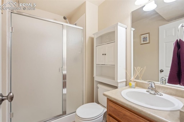 full bath featuring a stall shower, vanity, and toilet