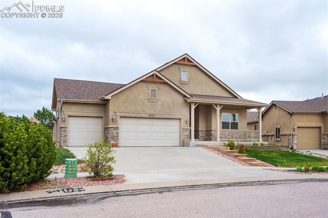 craftsman-style house with stucco siding, stone siding, covered porch, an attached garage, and concrete driveway
