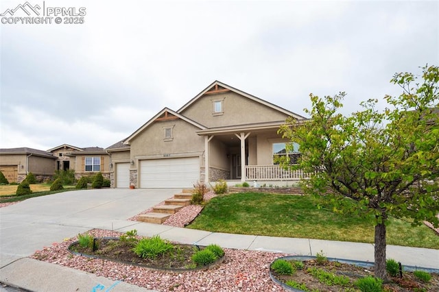 view of front of property with stucco siding, concrete driveway, stone siding, a porch, and a front yard
