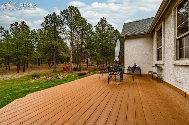 8360 Wranglers Way, Colorado Springs, CO 80908 - deck with outdoor dining space and a lawn
