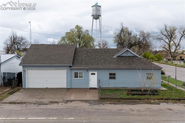 505 2nd Ave, Deer Trail, CO 80105 - view of front of property with roof with shingles, a garage, driveway, and fence