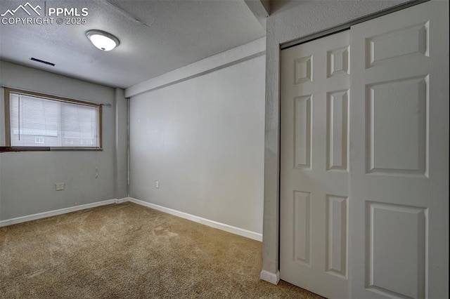 505 2nd Ave, Deer Trail, CO 80105 - unfurnished bedroom with carpet, baseboards, and a textured ceiling