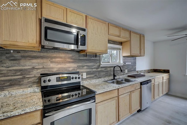 505 2nd Ave, Deer Trail, CO 80105 - kitchen featuring stainless steel appliances, light brown cabinets, a sink, decorative backsplash, and light wood-type flooring