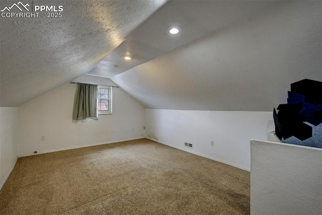 505 2nd Ave, Deer Trail, CO 80105 - additional living space with carpet, lofted ceiling, baseboards, recessed lighting, and a textured ceiling