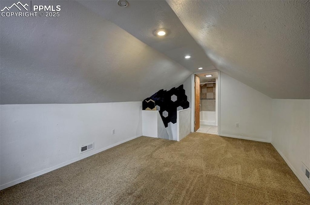 505 2nd Ave, Deer Trail, CO 80105 - additional living space with carpet flooring, a textured ceiling, vaulted ceiling, baseboards, and recessed lighting