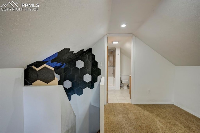 505 2nd Ave, Deer Trail, CO 80105 - additional living space with carpet, vaulted ceiling, a textured ceiling, baseboards, and tile patterned flooring
