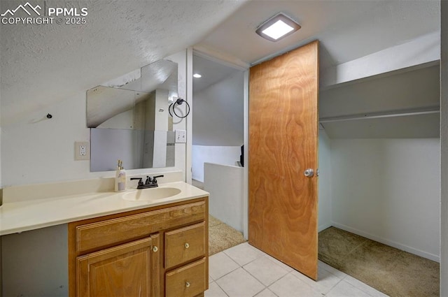 505 2nd Ave, Deer Trail, CO 80105 - bathroom with vanity, a textured ceiling, tile patterned floors, and lofted ceiling