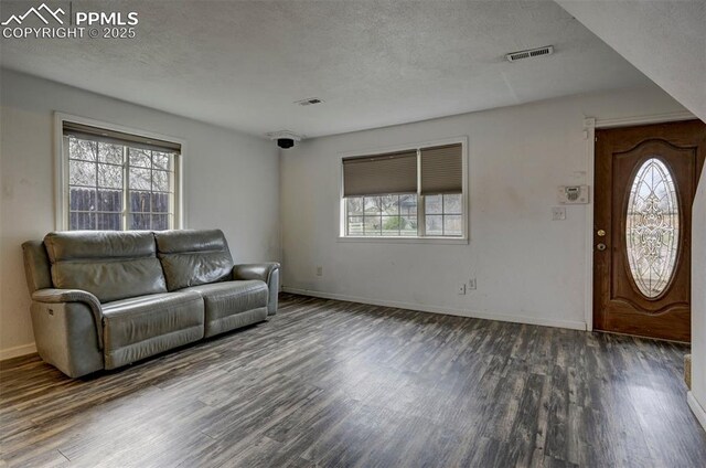 505 2nd Ave, Deer Trail, CO 80105 - living room featuring wood finished floors, a textured ceiling, and baseboards