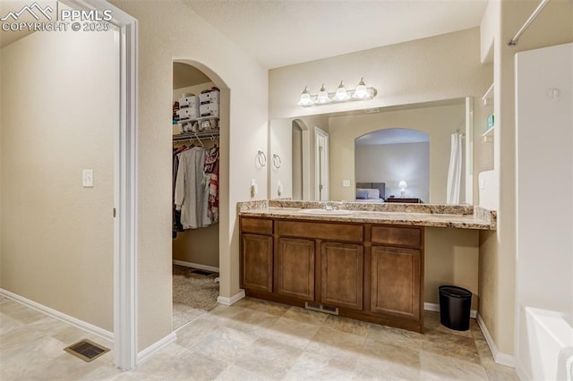 7567 Black Spruce Hts, Colorado Springs, CO 80908 - full bath featuring vanity, a spacious closet, and baseboards