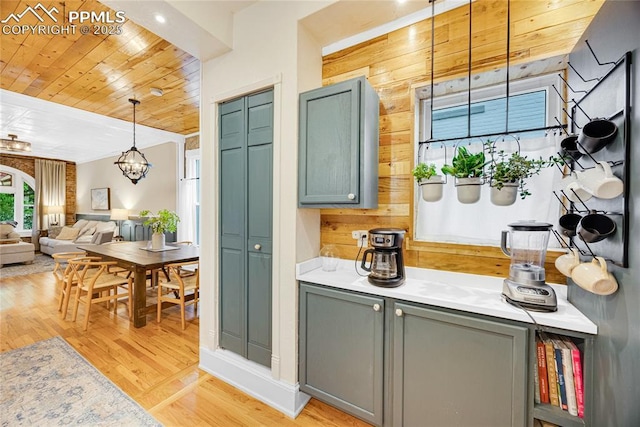 313 E Evans Ave, Pueblo, CO 81004 - kitchen with wooden ceiling, light wood-style flooring, light countertops, hanging light fixtures, and a chandelier