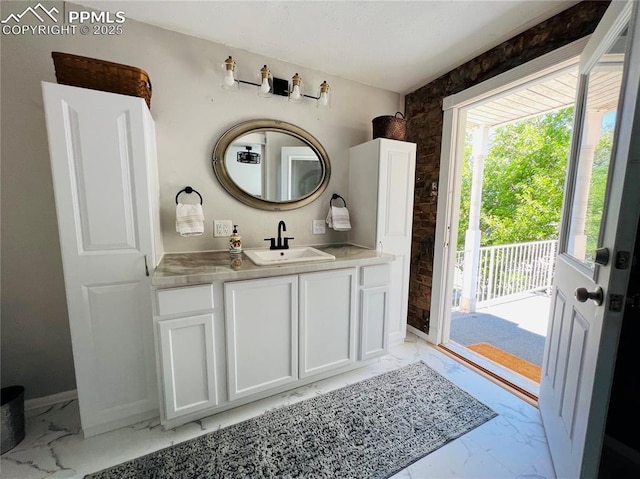 313 E Evans Ave, Pueblo, CO 81004 - bathroom with marble finish floors, vanity, and baseboards