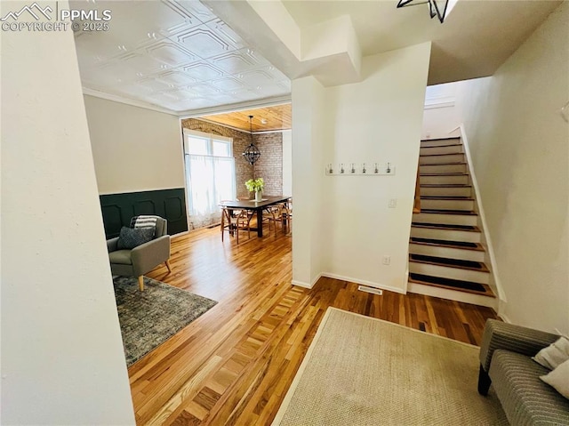 313 E Evans Ave, Pueblo, CO 81004 - hall featuring wood finished floors, stairs, baseboards, and an ornate ceiling