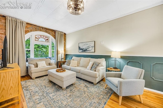 313 E Evans Ave, Pueblo, CO 81004 - living area featuring wood finished floors, an ornate ceiling, and crown molding