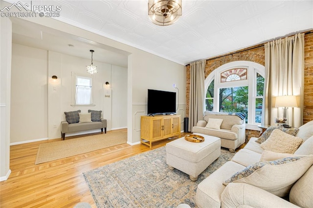 313 E Evans Ave, Pueblo, CO 81004 - living area featuring wood finished floors, an ornate ceiling, baseboards, and crown molding