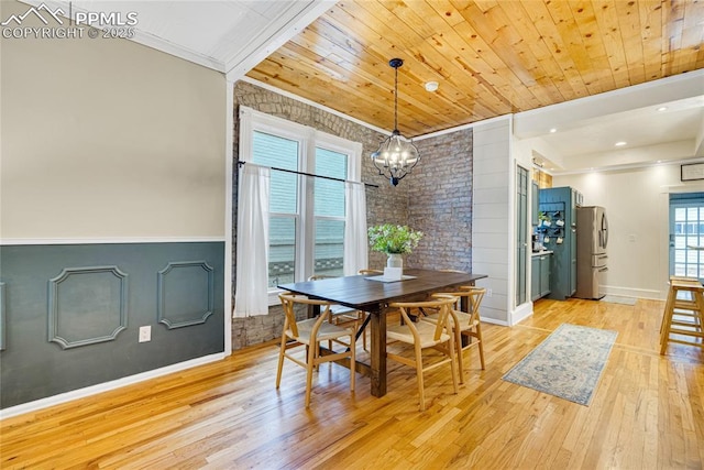 313 E Evans Ave, Pueblo, CO 81004 - dining room with light wood-style floors, a chandelier, crown molding, baseboards, and wood ceiling