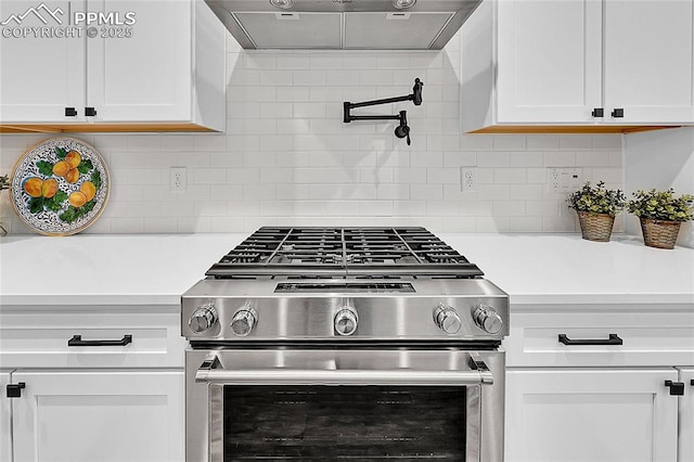6016 Haster Grv, Colorado Springs, CO 80927 - kitchen with stainless steel gas range oven, ventilation hood, light countertops, and white cabinets