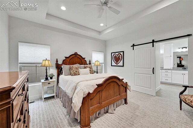 6016 Haster Grv, Colorado Springs, CO 80927 - bedroom with a barn door, ensuite bathroom, recessed lighting, ceiling fan, and baseboards