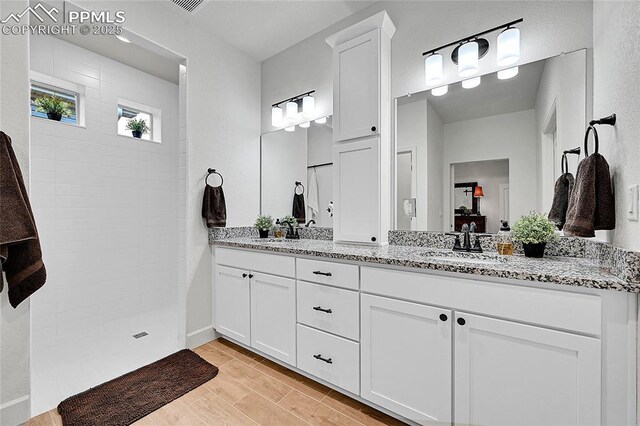 6016 Haster Grv, Colorado Springs, CO 80927 - full bath featuring walk in shower, double vanity, and wood finished floors