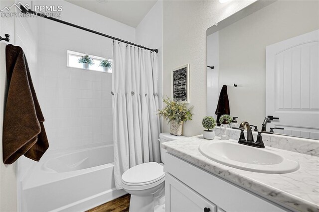6016 Haster Grv, Colorado Springs, CO 80927 - bathroom featuring toilet, vanity, wood finished floors, and shower / tub combo with curtain