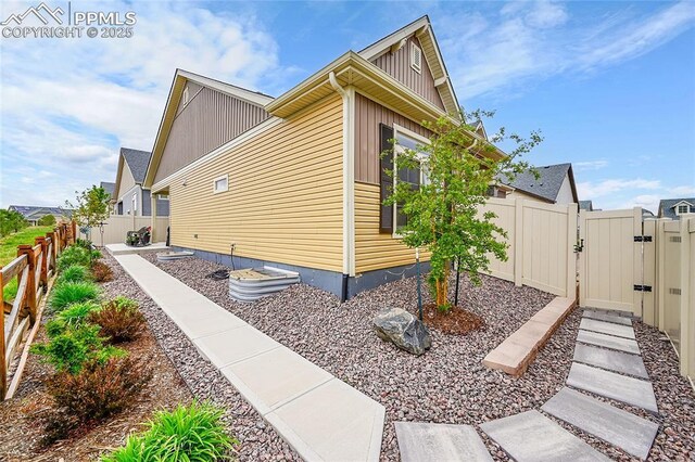 6016 Haster Grv, Colorado Springs, CO 80927 - view of side of property featuring a gate, fence, and board and batten siding