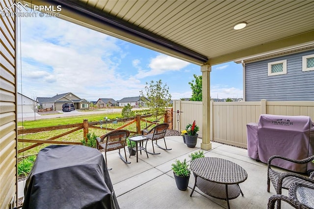 6016 Haster Grv, Colorado Springs, CO 80927 - view of patio / terrace featuring a grill, fence, and a residential view