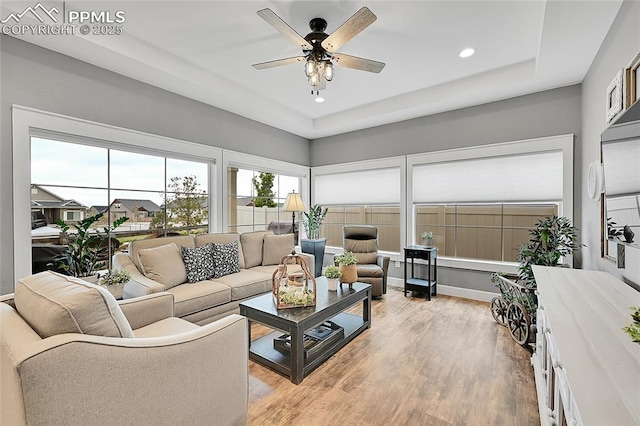 6016 Haster Grv, Colorado Springs, CO 80927 - living area with ceiling fan, light wood finished floors, recessed lighting, and a tray ceiling