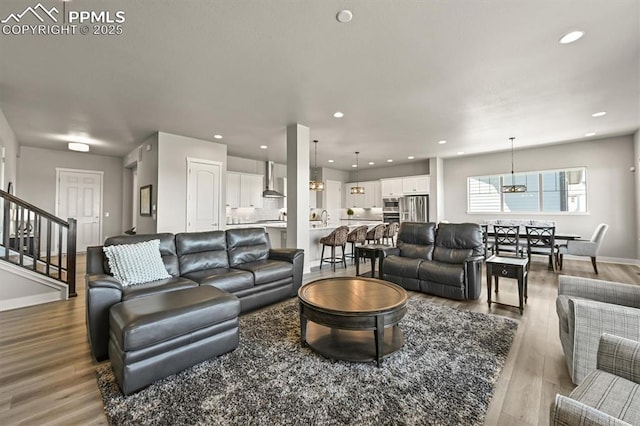 3293 Offbeaten Pl, Castle Rock, CO 80108 - living area featuring a chandelier, wood finished floors, recessed lighting, stairway, and baseboards