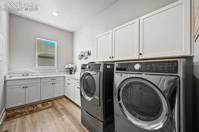 3293 Offbeaten Pl, Castle Rock, CO 80108 - laundry room with washing machine and clothes dryer, cabinet space, light wood finished floors, and recessed lighting