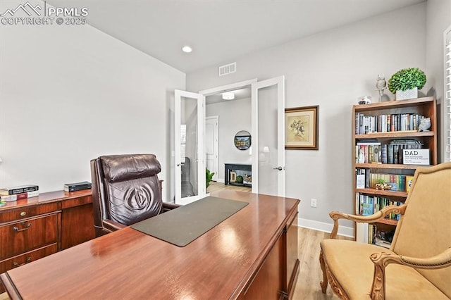 3293 Offbeaten Pl, Castle Rock, CO 80108 - office area with light wood finished floors, baseboards, a glass covered fireplace, and recessed lighting
