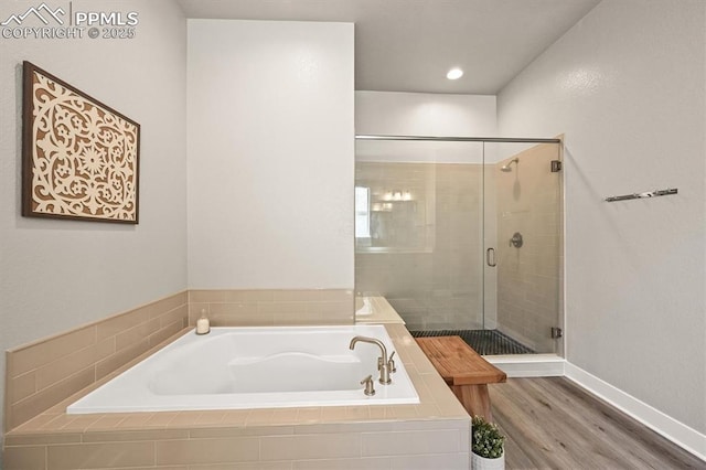 3293 Offbeaten Pl, Castle Rock, CO 80108 - full bath with a bath, a stall shower, wood finished floors, and baseboards
