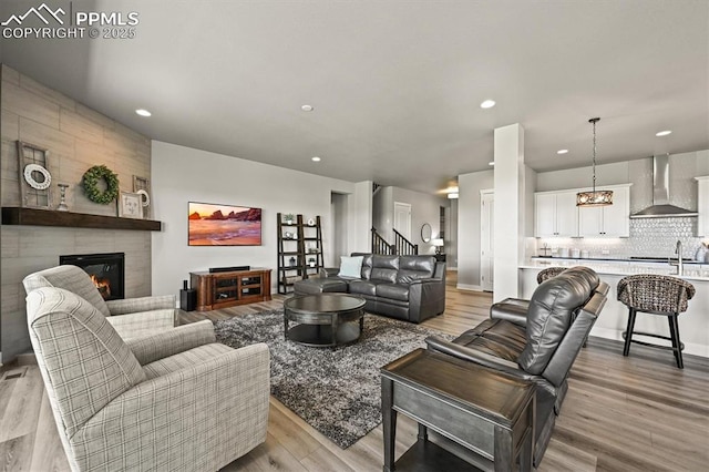 3293 Offbeaten Pl, Castle Rock, CO 80108 - living area with recessed lighting, a tiled fireplace, and light wood finished floors