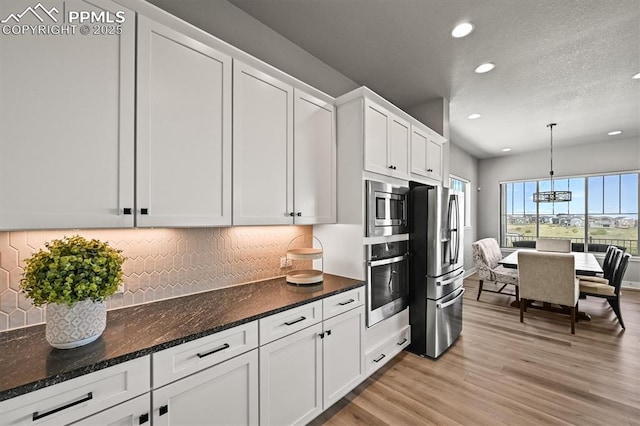 3293 Offbeaten Pl, Castle Rock, CO 80108 - kitchen featuring appliances with stainless steel finishes, recessed lighting, white cabinets, decorative backsplash, and light wood finished floors