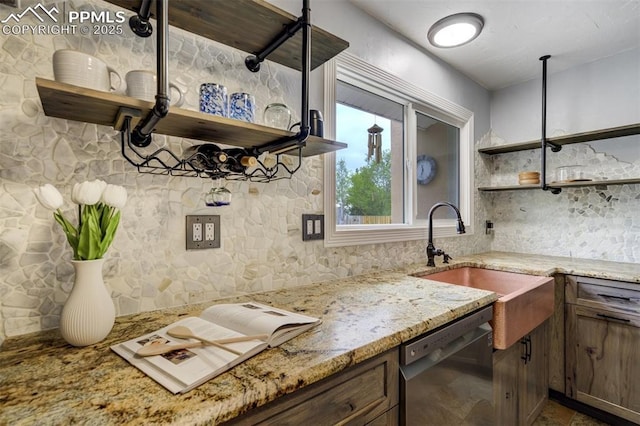 kitchen with open shelves, dishwasher, and light stone countertops