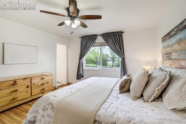 bedroom with wood finished floors and ceiling fan