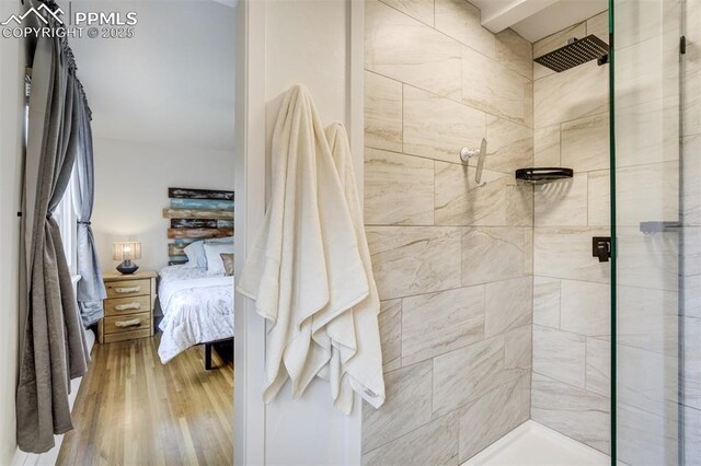 bathroom featuring a stall shower, ensuite bathroom, and wood finished floors