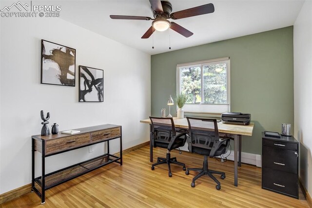 office area featuring light wood-type flooring, baseboards, and a ceiling fan