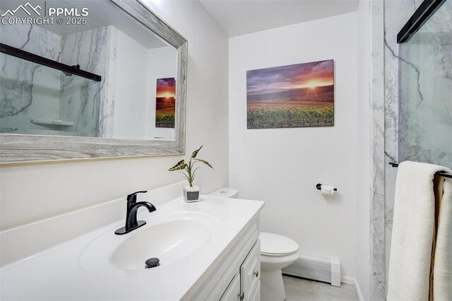 bathroom with vanity, toilet, tile patterned floors, and a marble finish shower