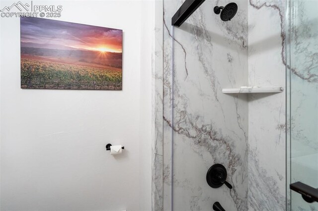 bathroom view of a marble finish shower