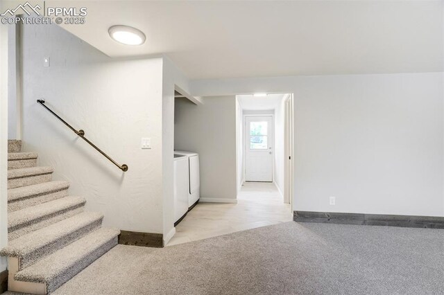 stairs featuring independent washer and dryer, carpet flooring, and baseboards