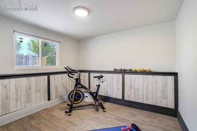 workout area with wood finished floors and baseboards