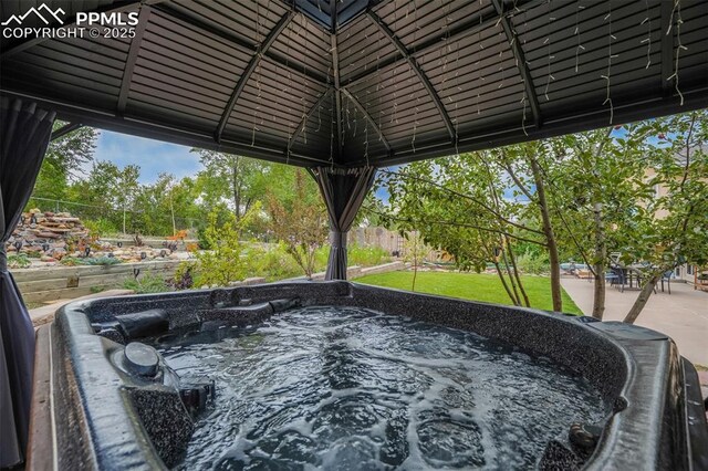 exterior space with a hot tub and a gazebo