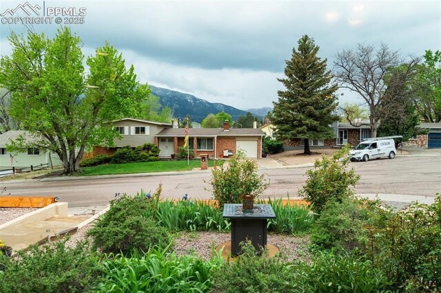 view of yard featuring a mountain view and an attached garage