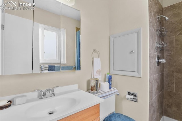 4344 E San Miguel St, Colorado Springs, CO 80915 - bathroom with tiled shower, vanity, and toilet
