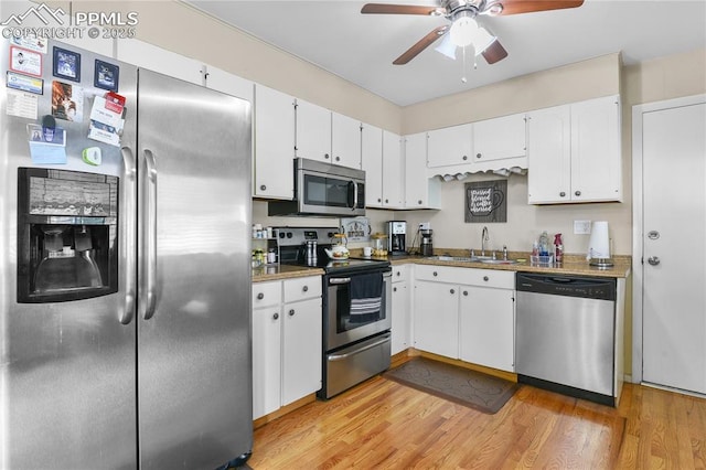 4344 E San Miguel St, Colorado Springs, CO 80915 - kitchen with stainless steel appliances, a sink, ceiling fan, white cabinets, and light wood-type flooring