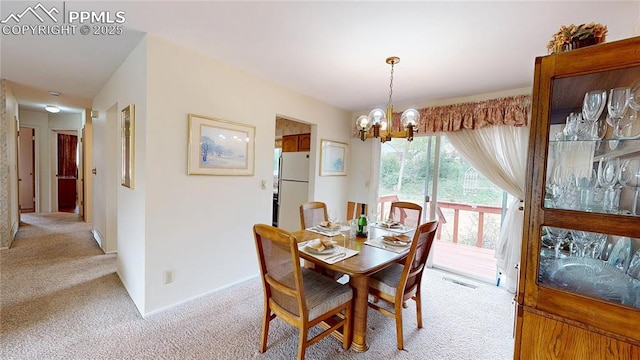 4012 Maxwell Pl, Colorado Springs, CO 80909 - dining area with light colored carpet and a chandelier