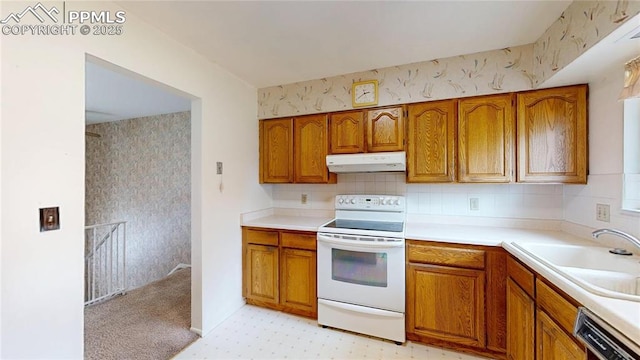 4012 Maxwell Pl, Colorado Springs, CO 80909 - kitchen featuring white electric range oven, under cabinet range hood, brown cabinetry, and dishwashing machine