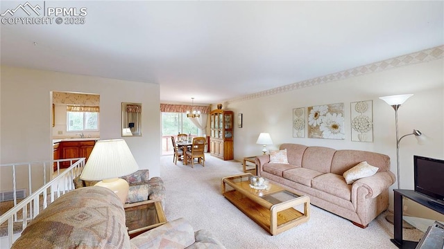 4012 Maxwell Pl, Colorado Springs, CO 80909 - living room featuring a chandelier and light carpet