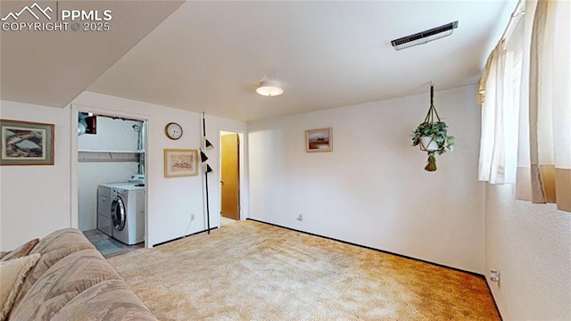 4012 Maxwell Pl, Colorado Springs, CO 80909 - carpeted living area featuring independent washer and dryer and baseboards