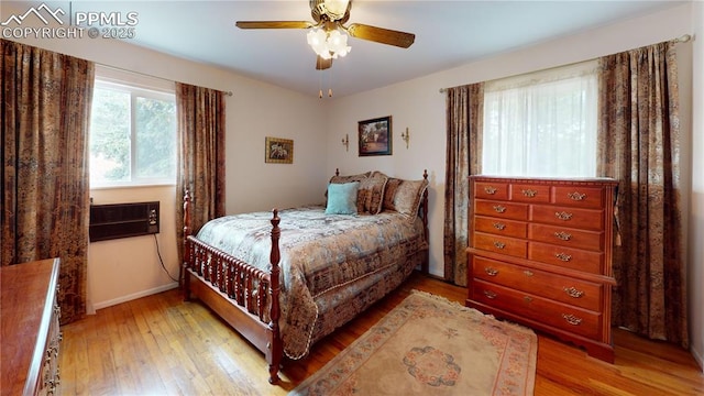 4012 Maxwell Pl, Colorado Springs, CO 80909 - bedroom with wood-type flooring, baseboards, a ceiling fan, and a wall mounted AC