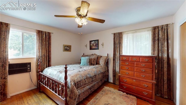4012 Maxwell Pl, Colorado Springs, CO 80909 - bedroom featuring hardwood / wood-style flooring, a wall mounted air conditioner, baseboards, and a ceiling fan